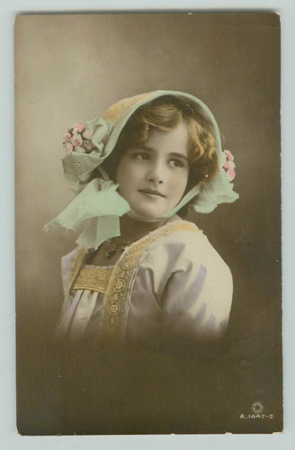 POSTCARD woman wearing bonnet, hand coloured. RPPC 1913