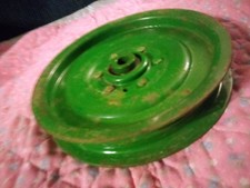 John Deere idler pulley. Flat. 6 7/8-inch diameter. 1/2-inch shaft.