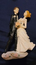 Vintage wedding cake topper. Figurine made of resin, depicting a bride and groom