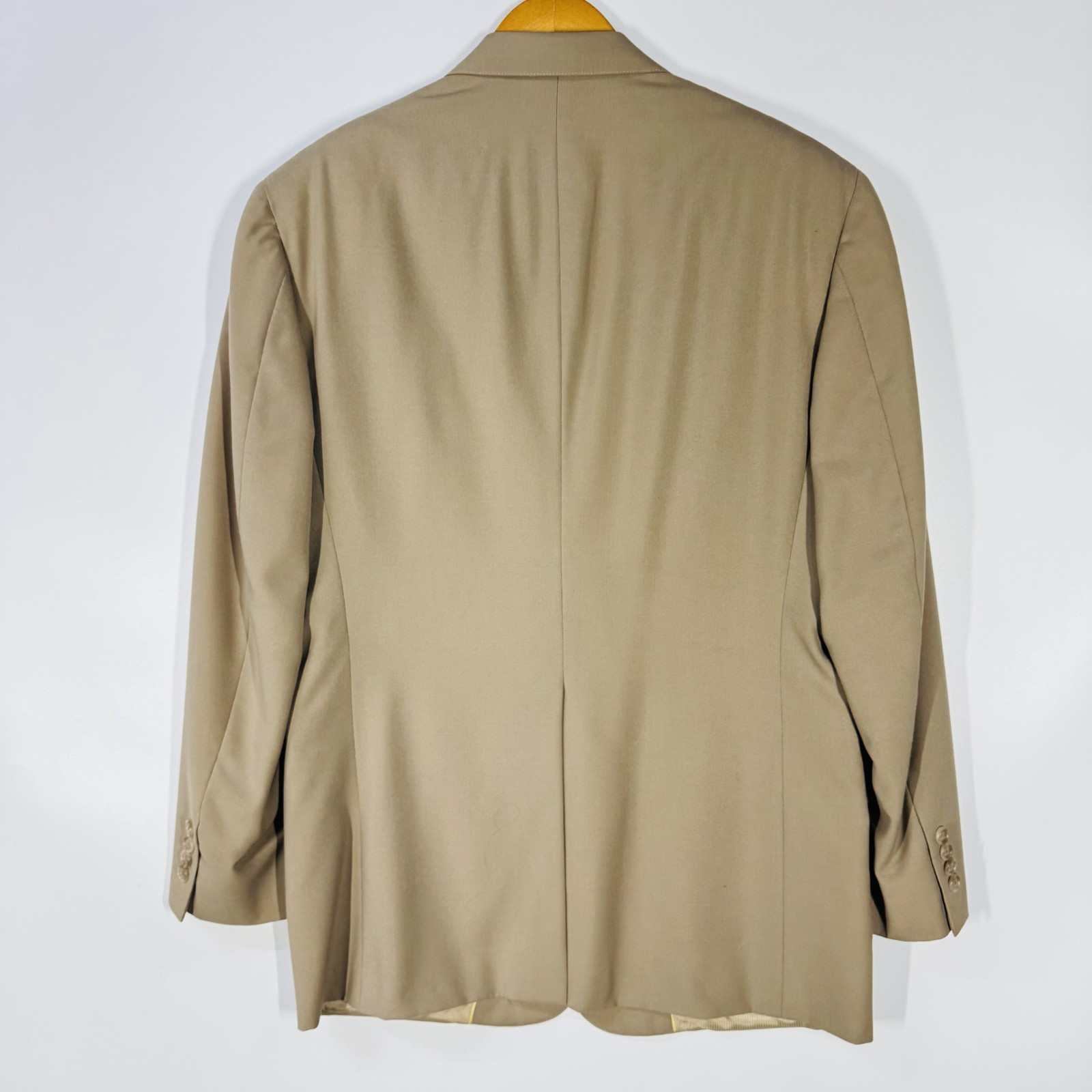 Ivory gold Austin Reed men's blazer with notch lapels, back zipper, and three-button closure, hanging on wooden hanger.