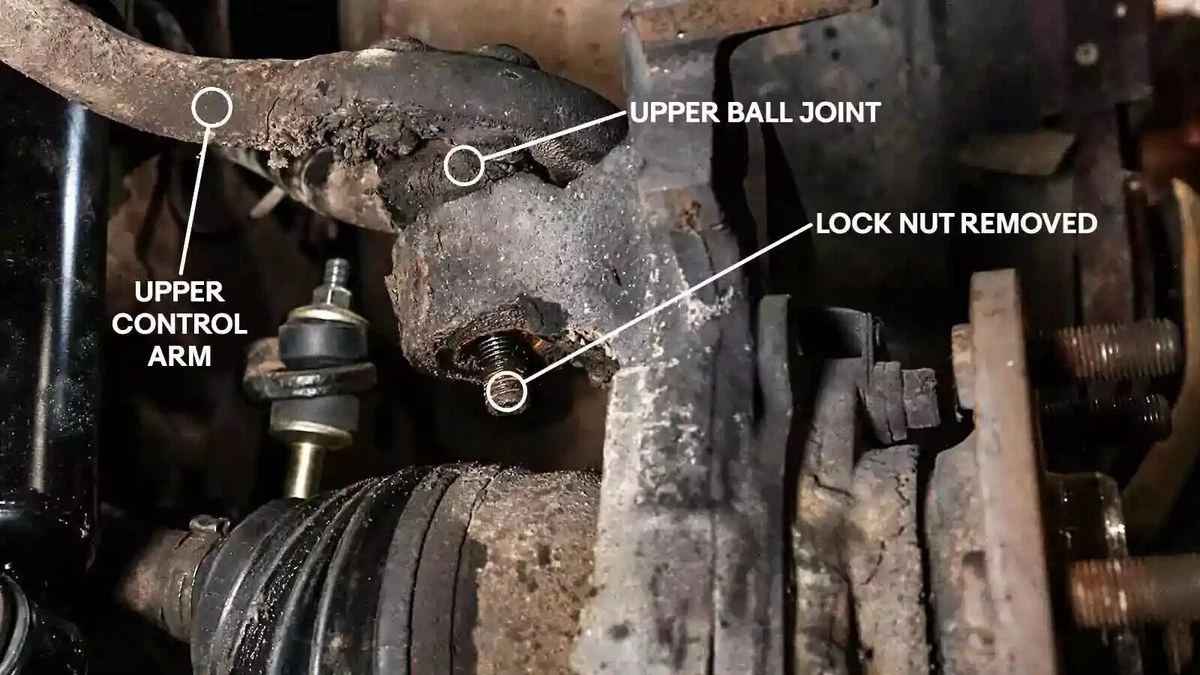 An annotated photograph shows the upper control arm and upper ball joint, along with the location of the lock nut.