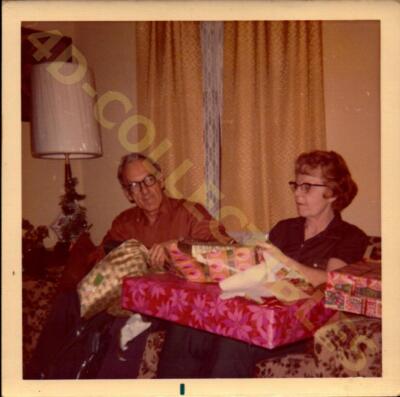 Vintage Snapshot Candid Photograph  Elderly Couple Sharing Christmas Gifts