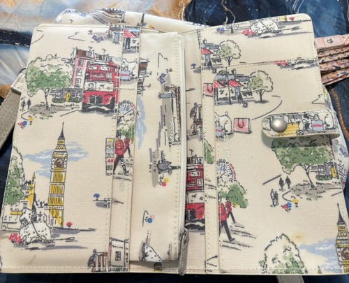 Cath Kidston travel wallet features the"Billie Goes to Town" London print.