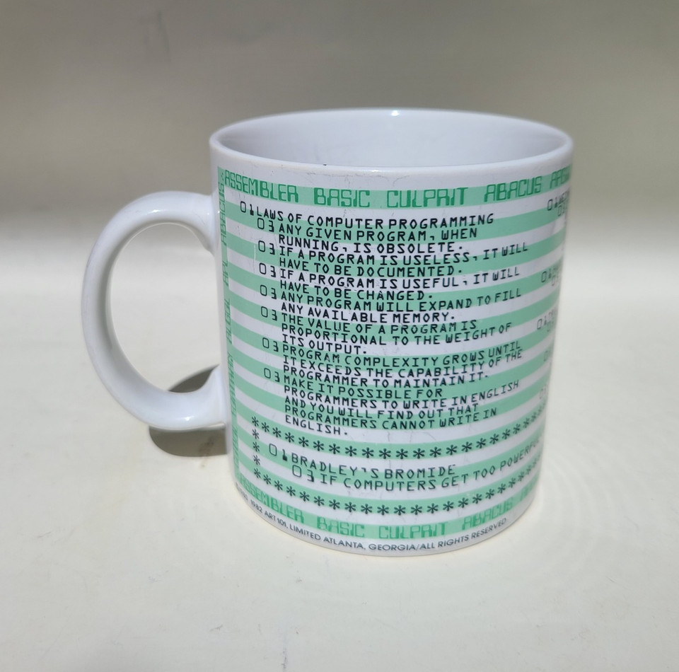 A vintage 80s mug riffing on Murphy's Law but for programming — nerdy, kitsch, and genuinely funny for anyone who's ever debugged code at 2am.