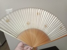 small vintage fan adorned with doves made of wood and canvas