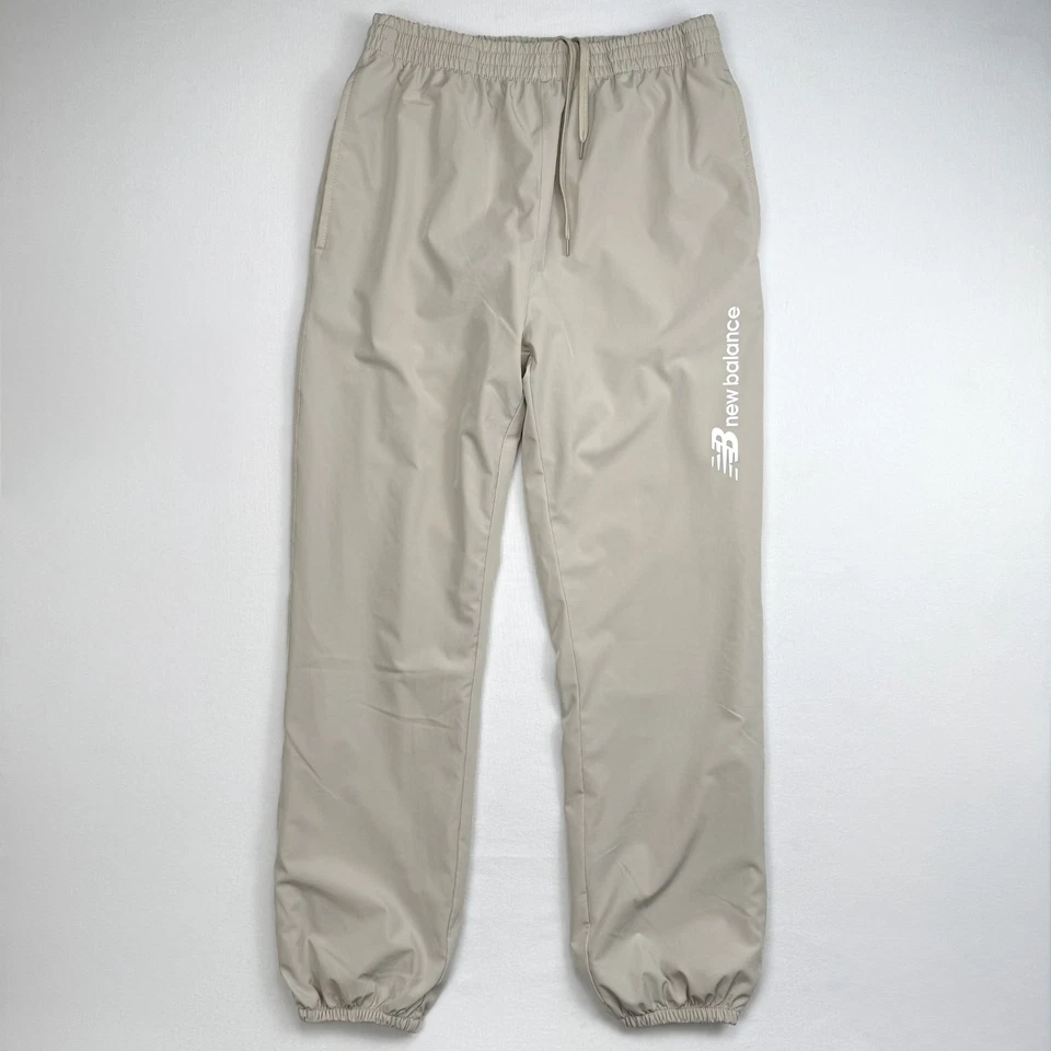 Pantalones de chándal New Balance cortavientos para hombre talla M beige forrados reflectantes Foto 2 de 4