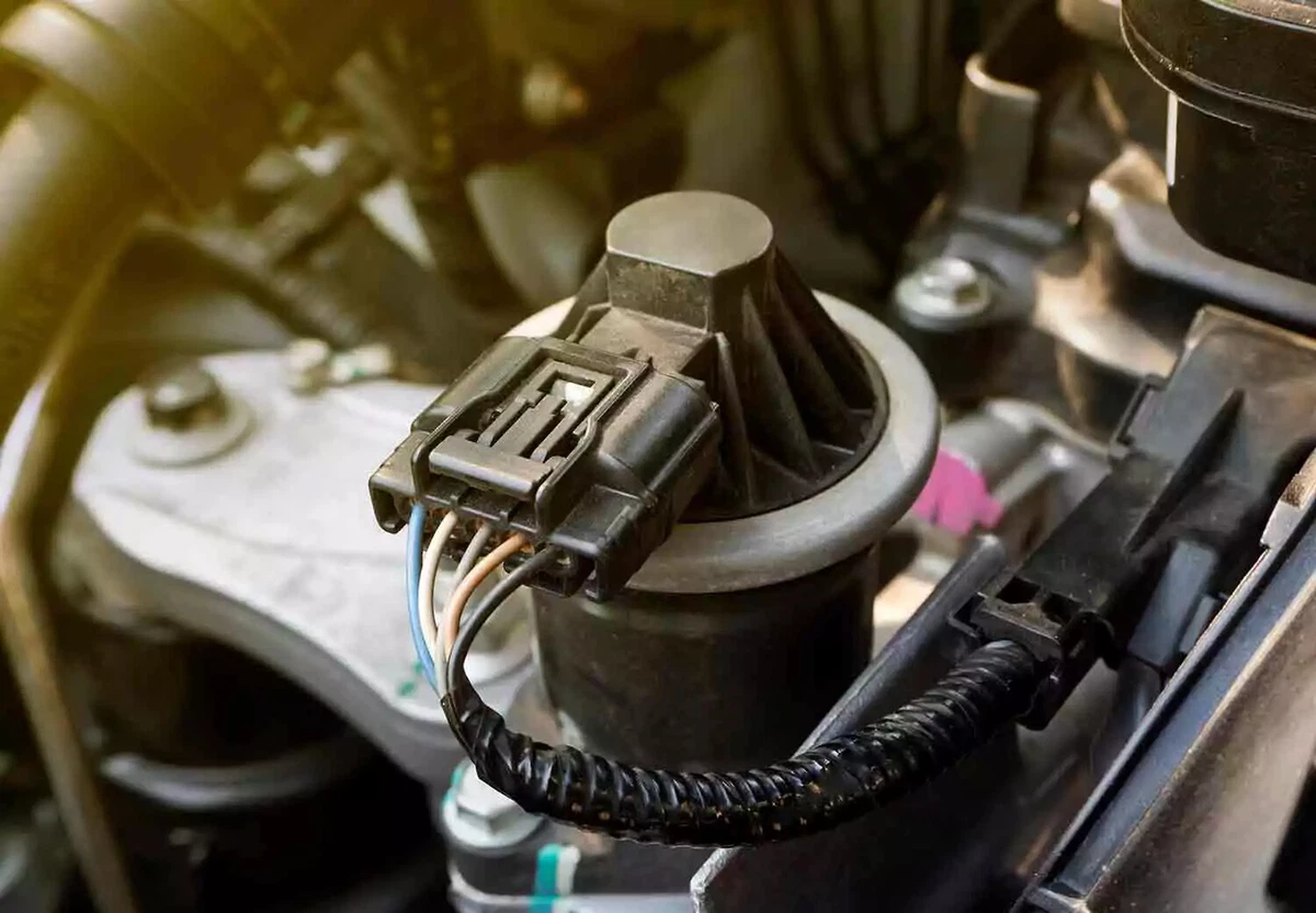 A connected EGR valve sitting in the engine of a vehicle.