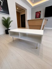 Modern white console / TV unit from Homesense with elegant brass-capped feet