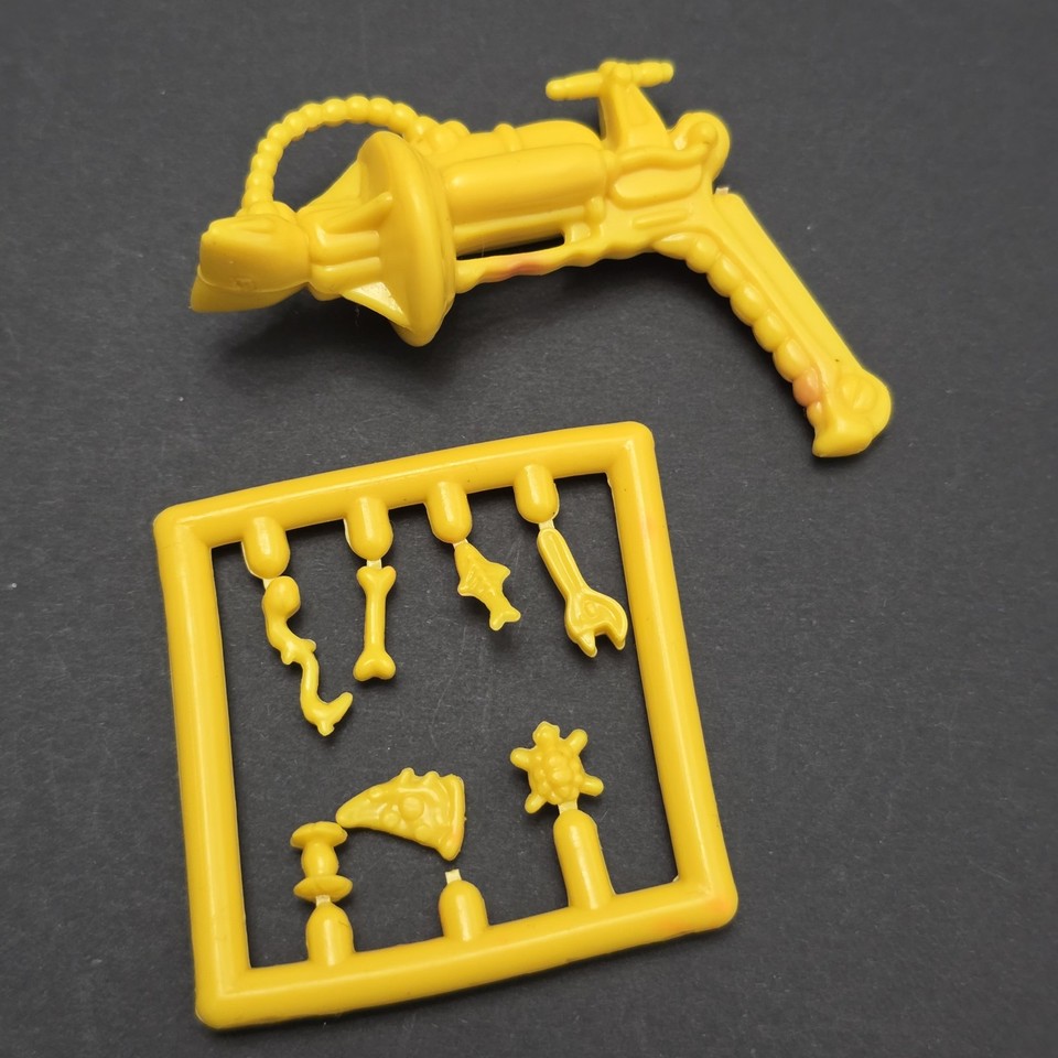 A loose lot of 1990 TMNT Mutagen Man parts — a genuinely obscure character whose accessories are a nostalgic goldmine for serious Turtle fans.