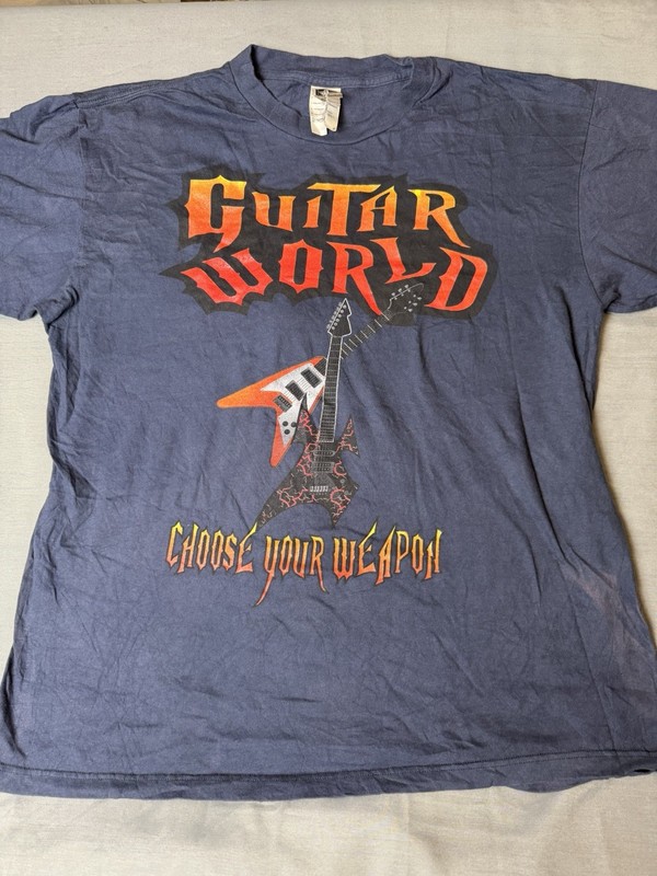 Guitar World, Choose Your Weapon T-Shirt. Guitar Hero. Size Large. Blue￼