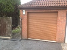 GARAGE DOOR  9 FT X 8FT NEW  INSULATED WITH 2 REMOTES  OAK