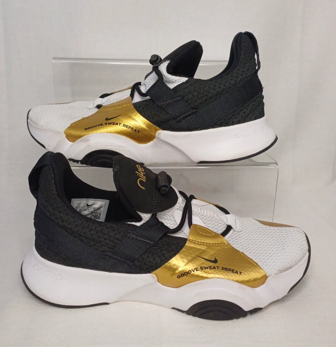 white and gold nike trainers