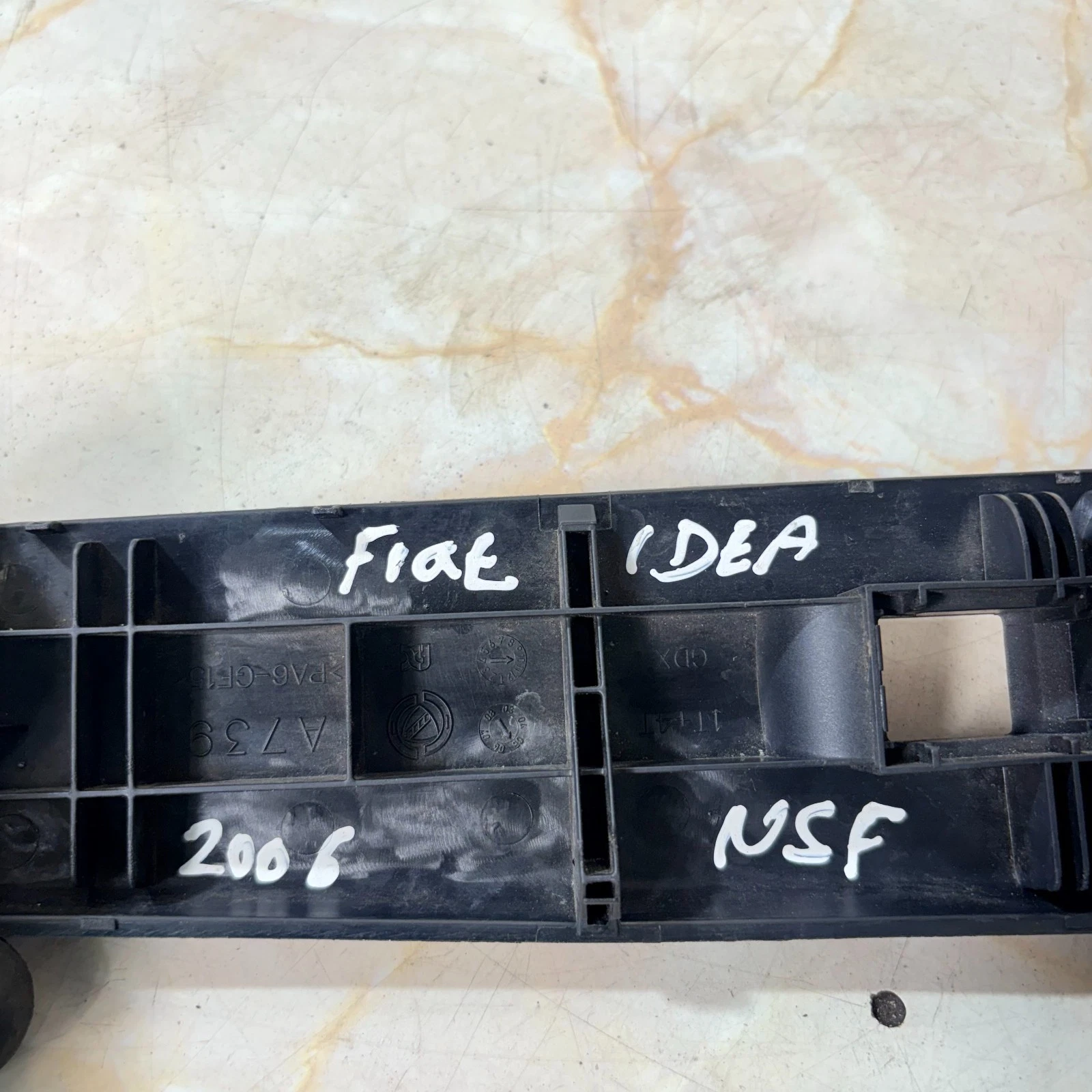 Reverse of Fiat Idea door handle switch marked 2006 NSF