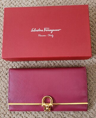 Close-up of the iconic Salvatore Ferragamo Gancini logo on a leather handbag