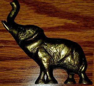 Small vintage cast brass elephant figurine with raised trunk