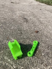 Green Traxxas Sledge Wing Spacer and Hobbywing Switch Mount.