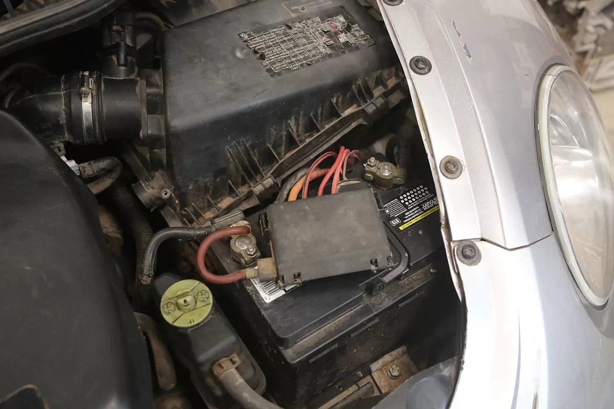 A vehicle's battery inside the engine compartment.