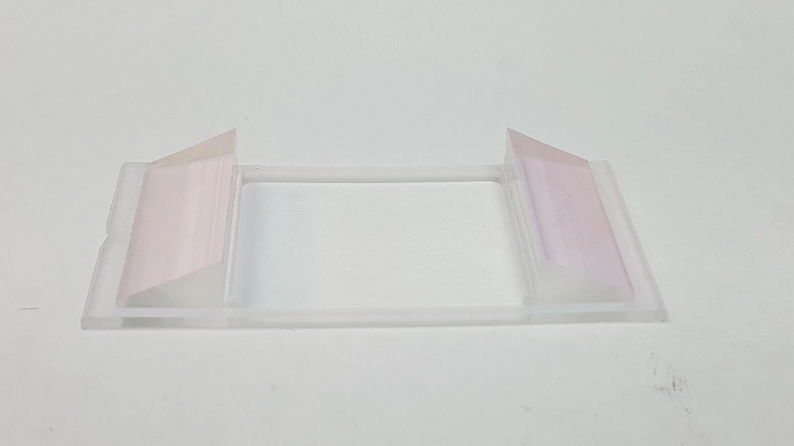 Angled view of the coated Fresnel lens with pink reflection on the end facets