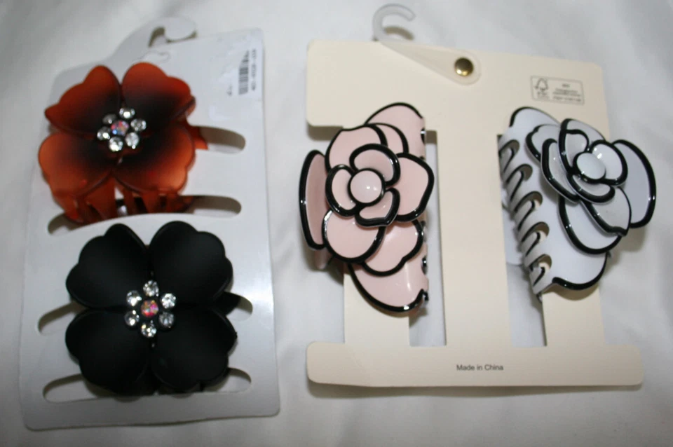 Juego de 2 pinzas para el cabello con forma de flores grandes. Blanco Marfil Negro Ámbar $9.99 CADA JUEGO Foto 2 de 2