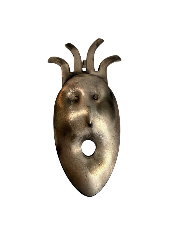 An upcycled metal spork turned into a punk-alien modernist brooch — wearable weirdness that's genuinely one-of-a-kind.