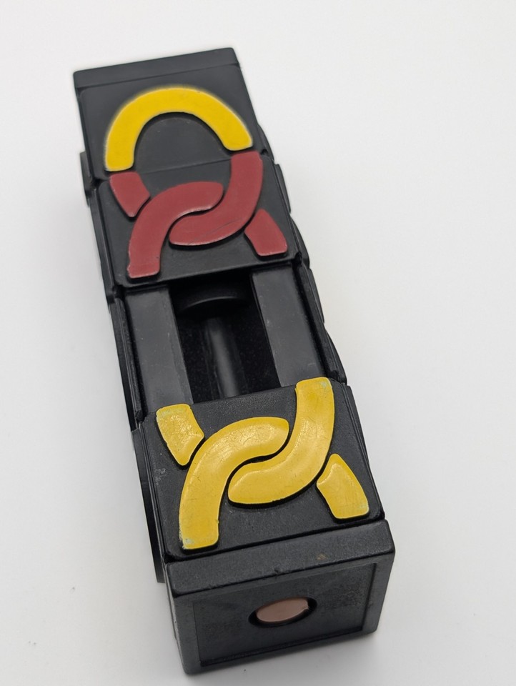 A rare 1980s black Tumbler Puzzle Tower twist brain teaser — the kind of satisfying tactile toy that disappeared before the internet could save it.
