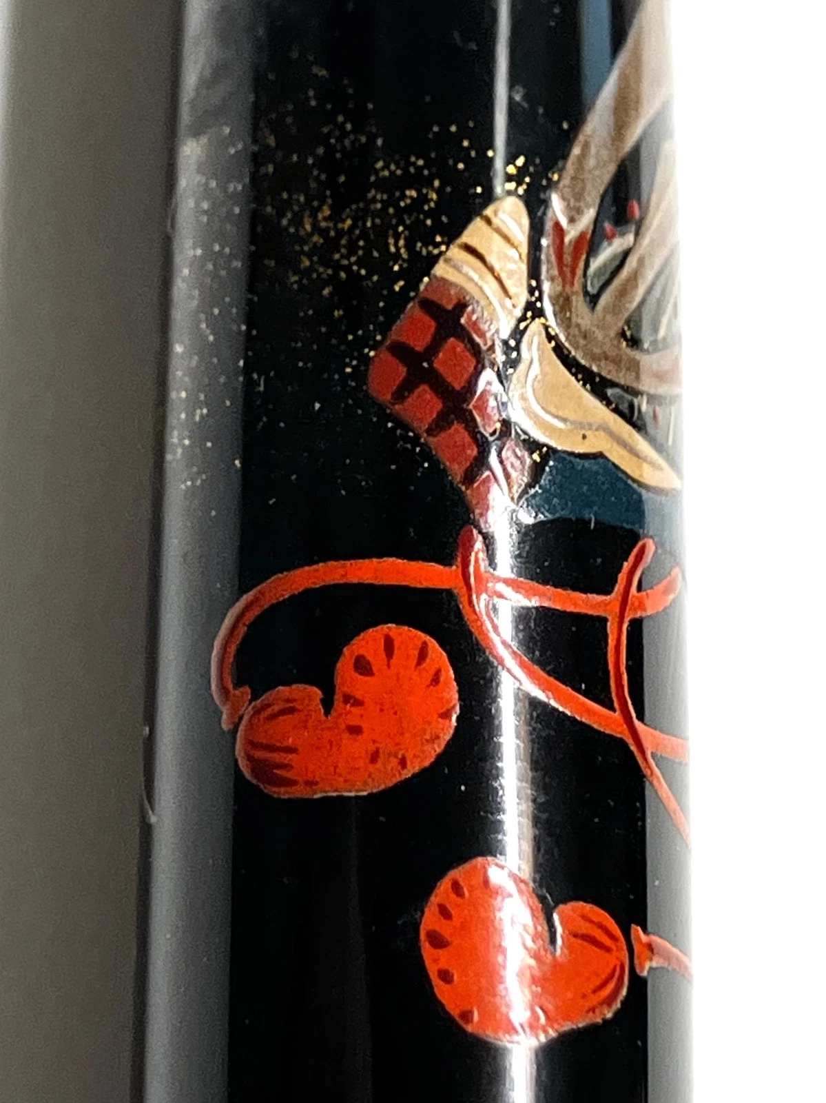 Black vintage fountain pen with red ink illustrations of crabs, clams, and other marine life on a glossy finish.