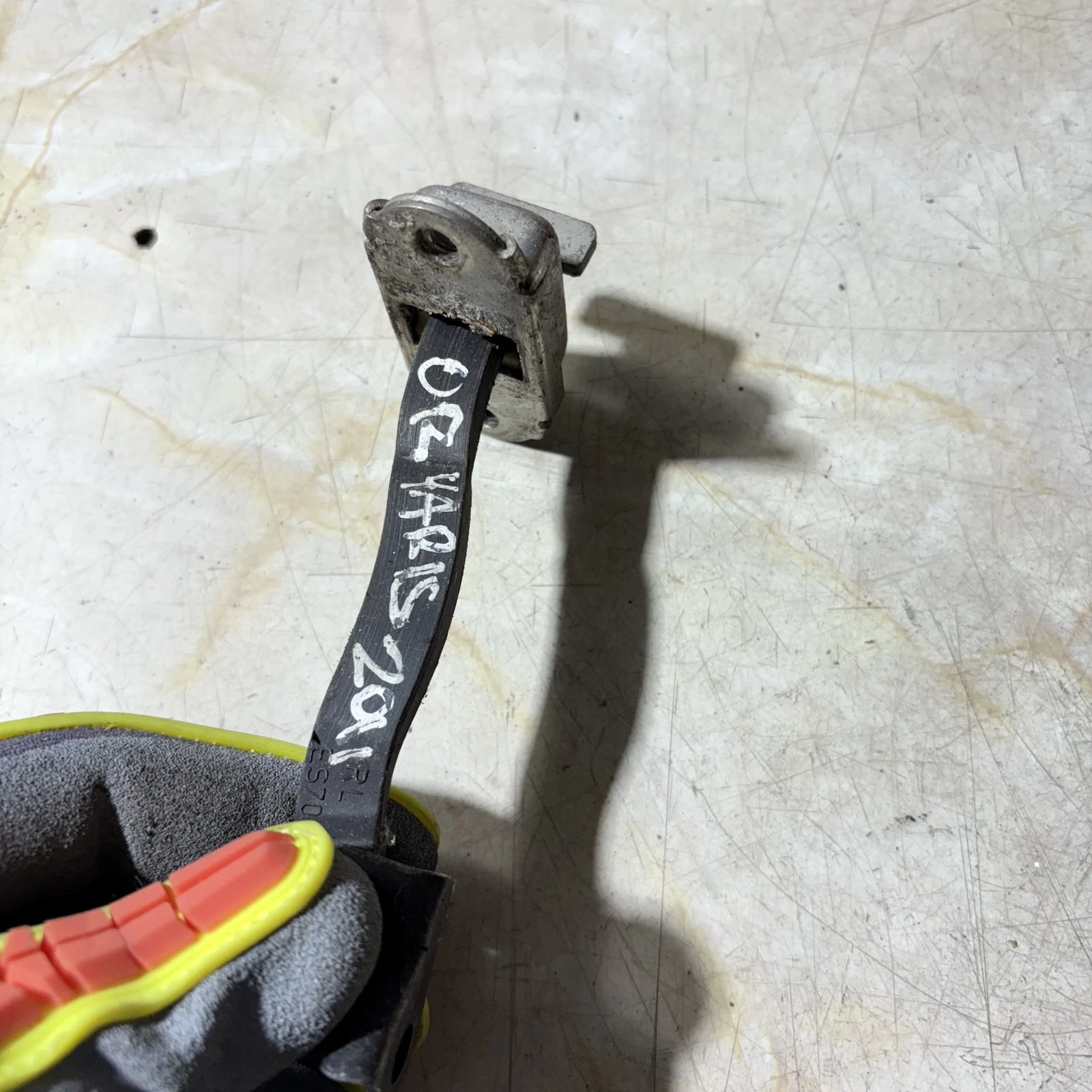 Toyota Yaris 2011 rear right door check strap visible ES70 marking