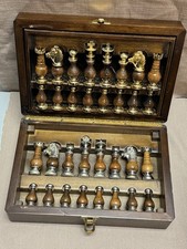 Vintage brass and wood chess set in a wooden storage case.