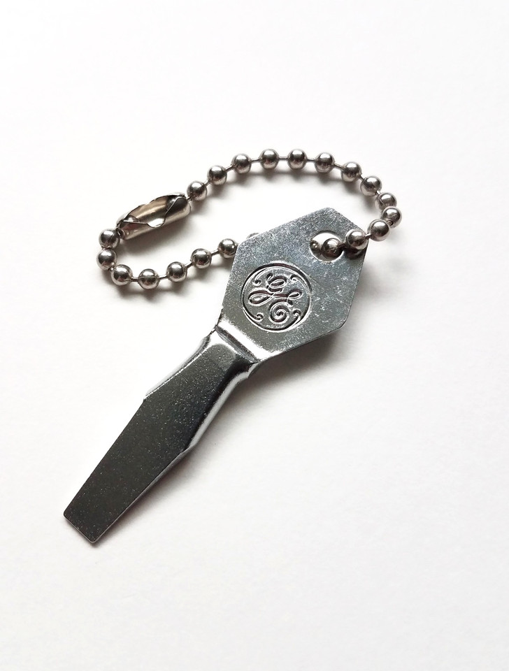A 1960s–70s General Electric branded pocket screwdriver keychain — tiny, functional corporate Americana that doubles as a conversation piece.