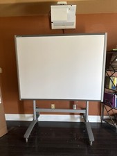 77" Smart Board with projector and remote, stand, pens, and erasers.