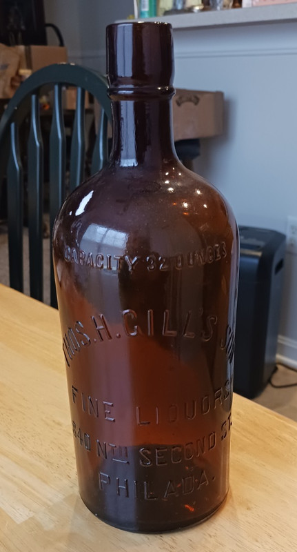 THOS. H GILL'S FINE LIQUORS AMBER EMBOSSED BOTTLE