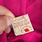 Pink Russell Athletic hoodie XL with white tag showing 50% cotton, 50% polyester, machine wash warm, and “Made in U.S.A.”