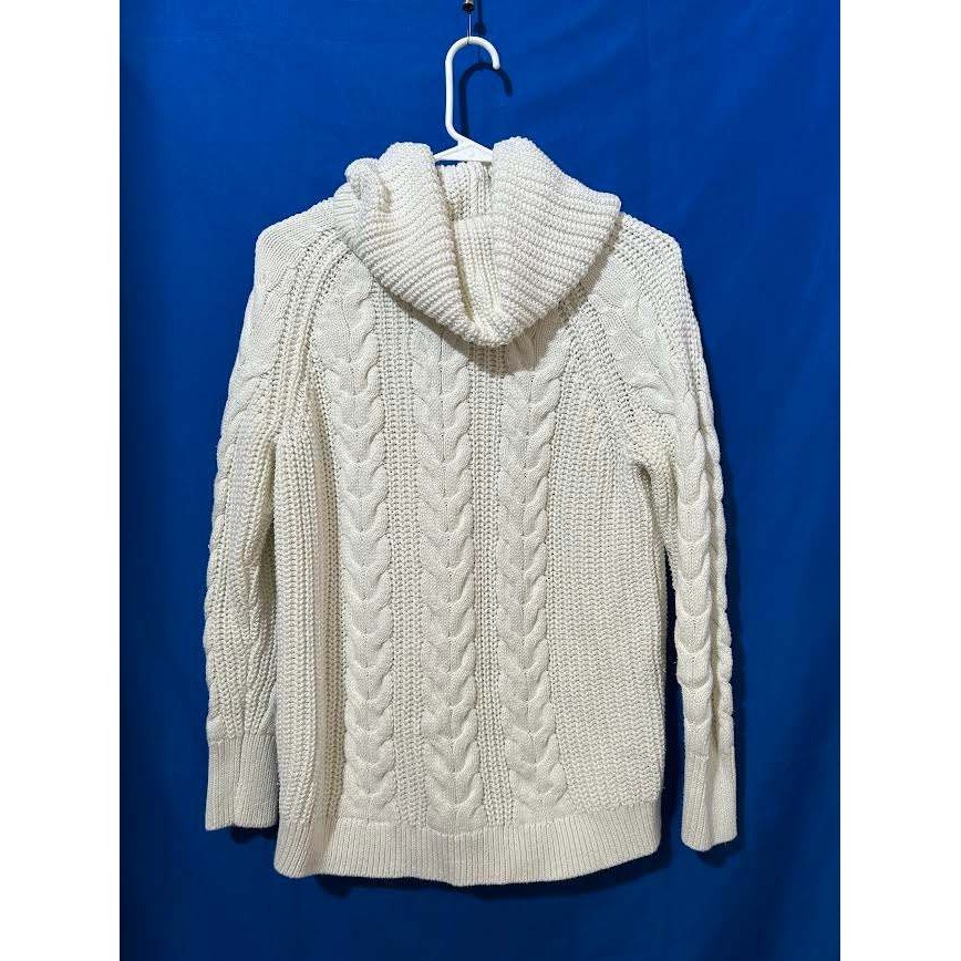 Cream cable-knit sweater with a cowl neck collar.