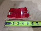 Red vintage 1970s 1980s Micro-Flex bike rim reflector with white text, shown beside a yellow measuring tape.