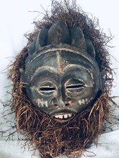 AFRICAN WOOD CEREMONIAL FACE MASK WITH RAFFIA TEETH SMILE OPENINGS FEMALE