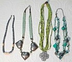 coral bead necklace, large silvertone hearts, green bead strands. You get all 4