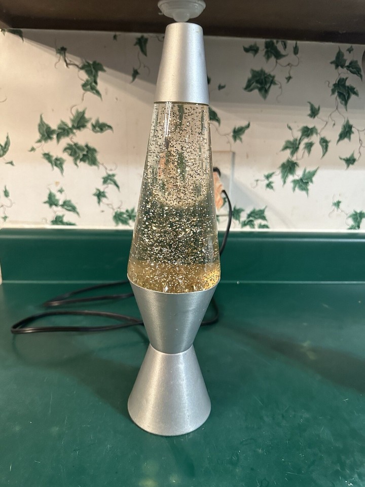 A sleek silver-and-gold glitter lava lamp with fast action motion — the metallic palette feels more grown-up than the typical rainbow versions.