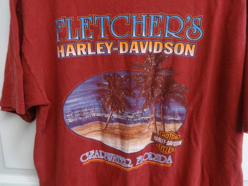Men’s XL T-shirt with blue “Fletcher’s Harley-Davidson Clearwater, FL” text and tropical tree graphics.
