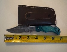 pocket knife with damascus blade and leather sheath