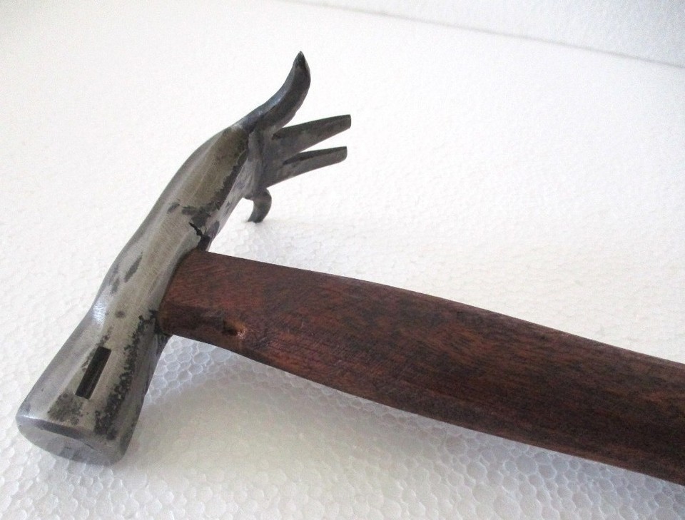 A figural antique hammer where the tool itself IS the sculpture — the kind of one-of-a-kind object that blurs the line between folk art and working tool.