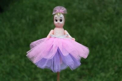kewpie doll on stick