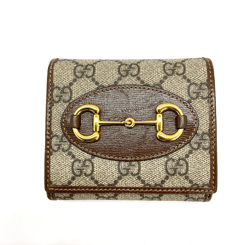 Portefeuille compact Gucci d'occasion N 621891 Gg Supreme Horsebit marron or marque quincaillerie