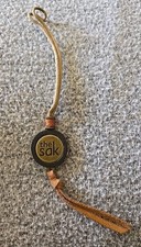 THE SAK Metal Tone  Wood Disc Purse Charm Bag Hangtag Fob