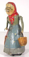 ca1900 GUNTHERMANN TIN WIND UP / CLOCKWORK OLD WOMAN WITH A BASKET AND UMBRELLA