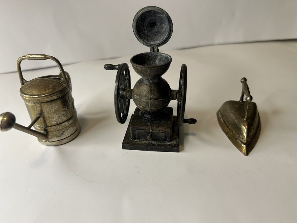 A tiny cast-metal coffee grinder that's actually a pencil sharpener — miniature Victorian kitsch that earns a double-take on any desk.