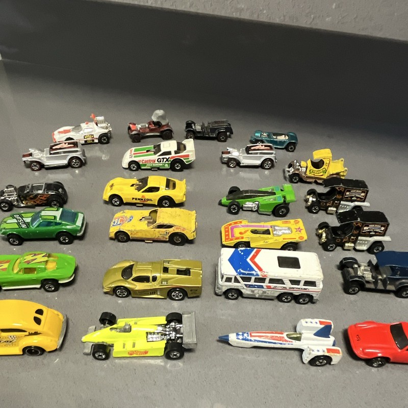 24 Hot Wheel Cars 1960’s-1990’s. Two older red lines.