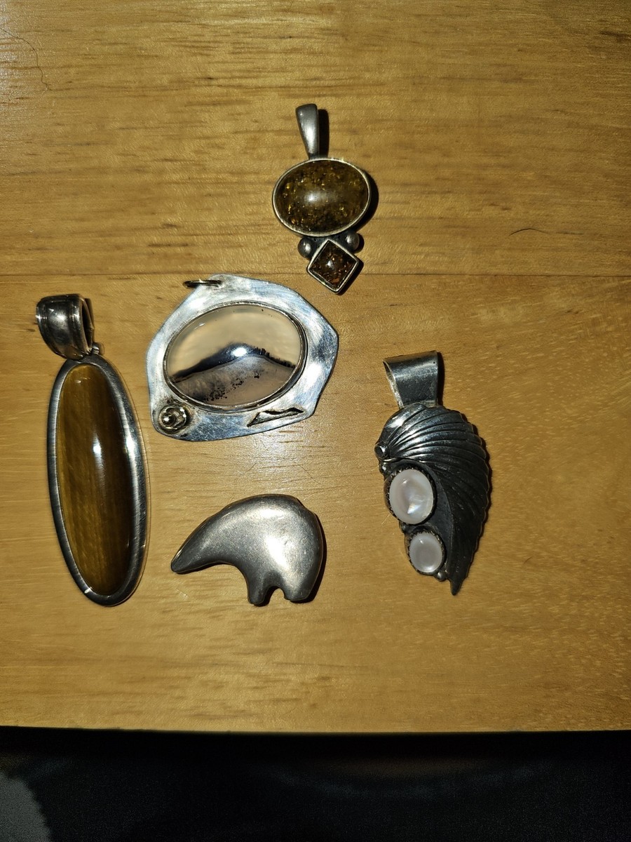 Multiple Silver And Stone Pendants.