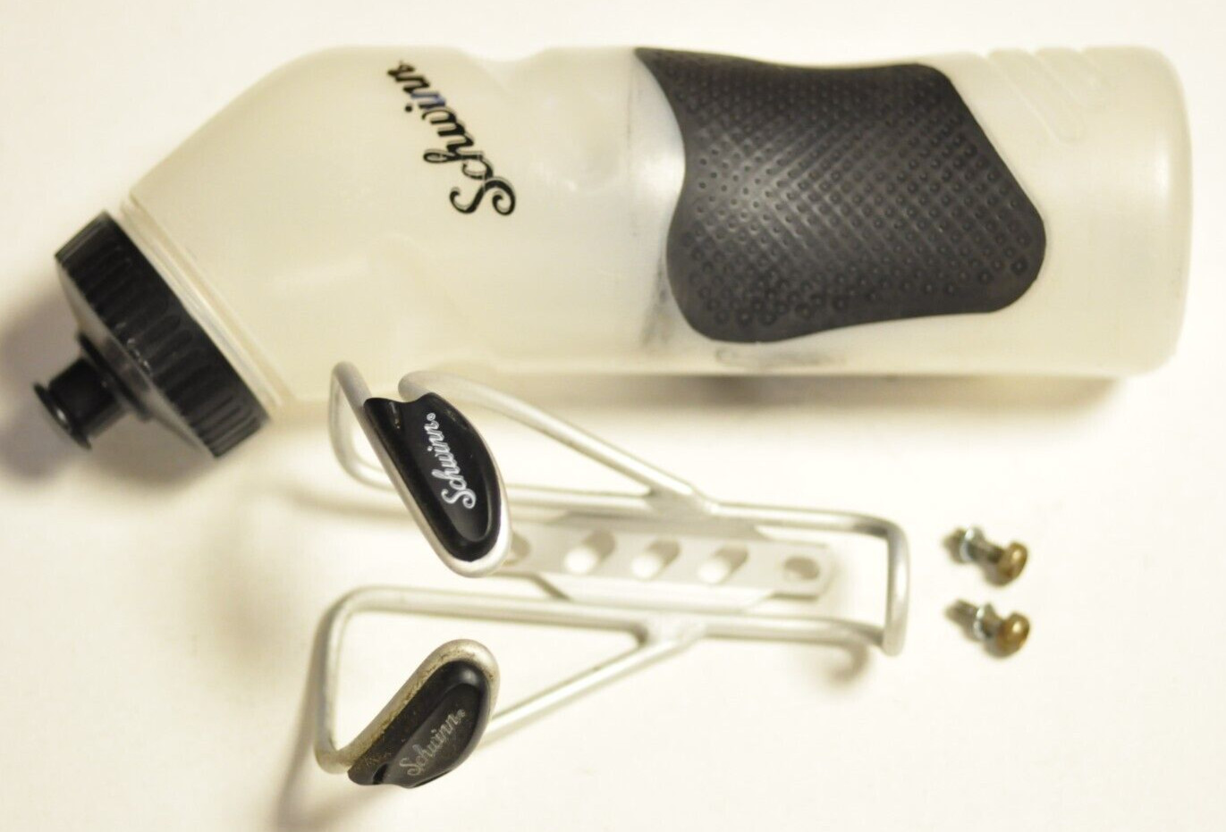 Schwinn bike water bottle cage with water bottle and hardware.