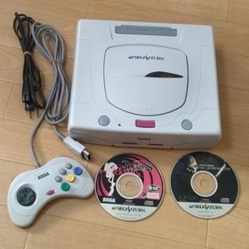 Sega Saturn console, software, and controller set.