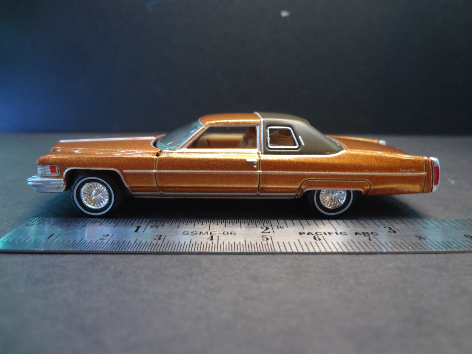 Auto World 1976 Cadillac Coupe DeVille Amberlite Firemist - Loose 1:64